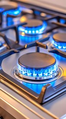 Close-up of a modern gas stovetop with multiple burners ignited, showcasing vibrant blue flames