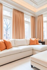 Luxurious living room with creamy sectional sofa, orange throw pillows, and light peach curtains, all set against large windows and crown molding