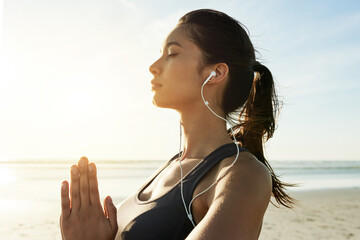 Girl, earphones or beach meditation for sunset zen, manifestation or mindfulness gratitude. Mudra, namaste or binaural frequency music for mental health, wellness or anxiety relief in nature space