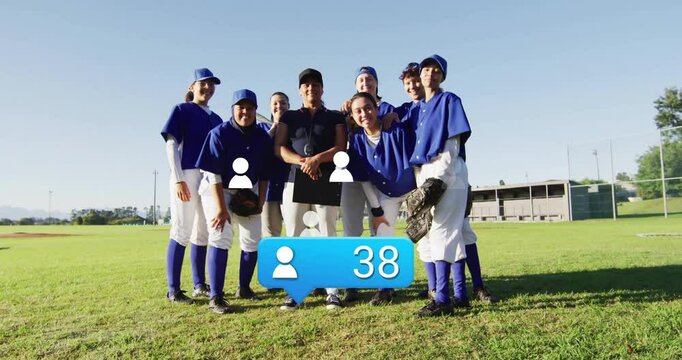 female baseball players posing with coach using clipboard on baseball field, showing animated stats