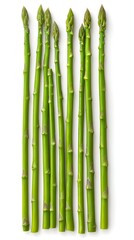 Fototapeta premium Nine spears of fresh green asparagus arranged vertically against a white background