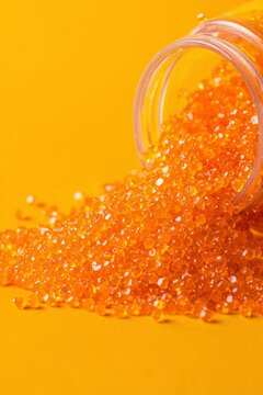 Orange granules spilling from container