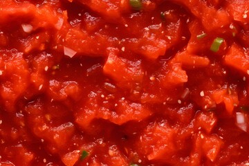 Chunky tomato sauce seamless pattern with diced vegetables. Fresh homemade marinara texture for pasta, pizza, or cooking background. Red Italian food ingredient closeup