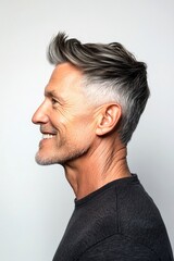 Obraz premium Chic men's classic short back and sides haircut - midlife white man with grey hair. A happy and stylish male showing grace. Visual idea art of style for aging men. Pure white solid background.