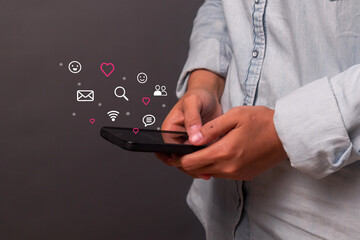 A young woman using a smartphone to open social media applications. Online dating, chat with friends, and send emotion icons.