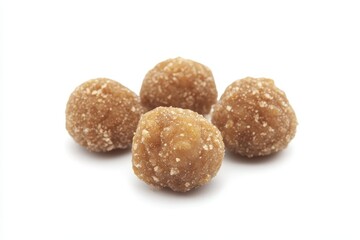Close-up of four round, sugar-coated snack balls on a white background, ideal for food photography