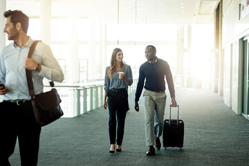 Business, team and walking with luggage at airport for international trip, convention and arrival...