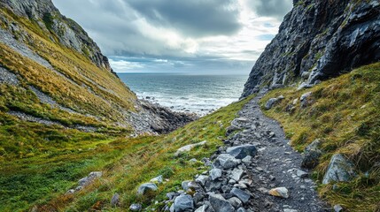 A dramatic scene of a rocky mountain slope leading down to a wild coastline, perfect for adventurers looking for scenic hiking paths.