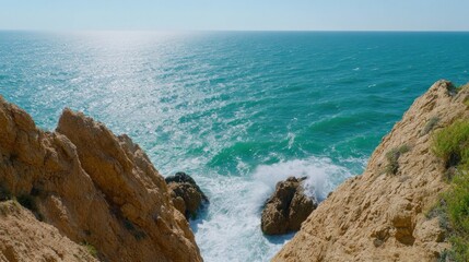 Rocky coastline meets the turquoise sea.  Waves crash against the cliffs