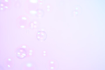 Beautiful Shiny Soap Bubbles Floating in The Air. Celebration Festive Backdrop. Freshness Soap Suds Bubbles Water. Purple and White Gradient Textured. Abstract Blurred Background.