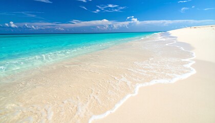 Pristine white sandy beach with turquoise water and clear blue sky, creating a tranquil and inviting tropical paradise.
