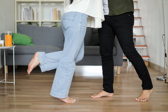Romantic couple hugging and swaying joyfully in the living room.