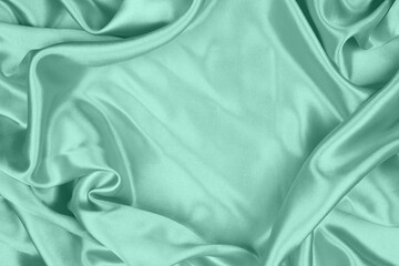 Smooth elegant green silk or satin texture can use as abstract background