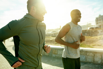 Men, laughing or running for city fitness, exercise or workout wellness on promenade with summer flare. Friends, joke or funny personal trainer with athlete for marathon, race or competition training