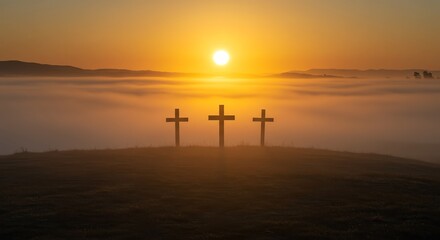 Three Crosses Silhouetted on Hill at Sunrise with Foggy Sky