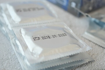 condom packet display manufacturing and expiration dates on surfaces