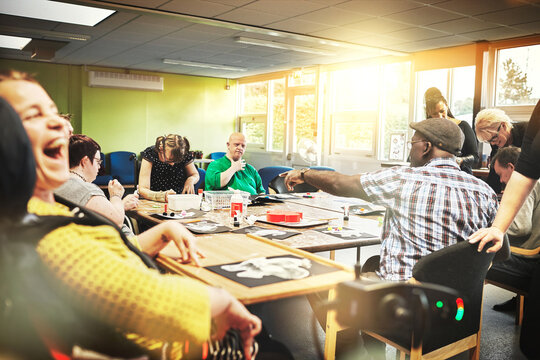 Autism, down syndrome and disability people community learning library room for creative activity, skills and physical therapy development. Happy group special needs patients in disabled school care