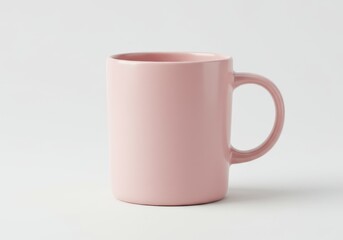 Obraz premium A single pink ceramic mug with a handle is displayed against a plain white background in a studio shot