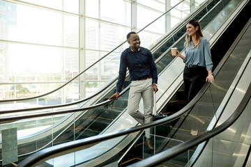 Escalator, talking and luggage with business people in airport together for travel or trip....