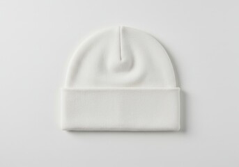 Fototapeta premium A simple studio shot of a plain white beanie hat isolated on a white background with soft lighting