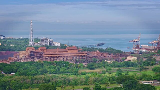 Aerial view of heavy industrial plants lining the shoreline of Cagayan de Oro, Mindanao, Philippines, showcasing coastal manufacturing infrastructure.