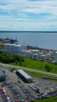 Aerial view featurinmg large industrial complex situated near sea.