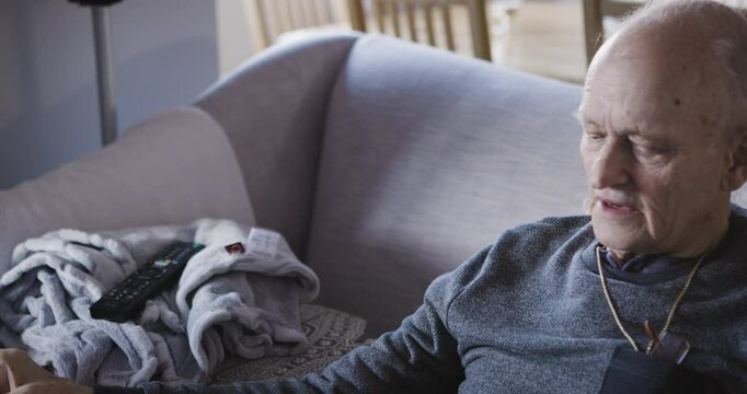 Retirement, senior man and milk drink for strong bones and healthy body in a nursing home. Assisted living, mature male and calcium or dairy drinking for a health diet and nutrition on the couch
