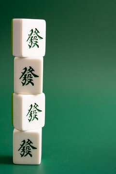 Close-up of mahjong tiles on a green surface,Mahjong (mah jongg, mah-jongg, and mahjongg) is a tile-based game that was developed in the 19th century in China