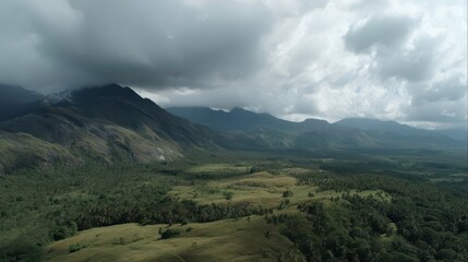 Fototapeta premium Lush Green Mountain Landscape Under Dramatic Cloudy Sky, Travel Destination