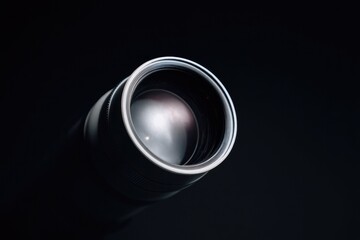 close-up of telescope lens against minimalistic dark background
