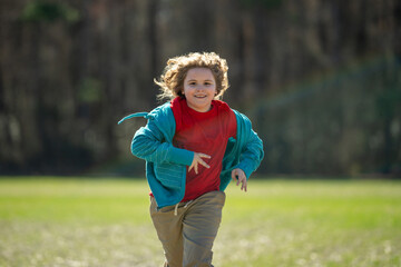 Child run fast in park. The child runner run and sprint outdoors. Kid run with fun. Outdoor sports kids healthy. A child runs through nature. The run motion of carefree kid. Running and jogging kids.