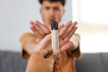 Young boy refuses disposable cigarette. No smoking concept.
