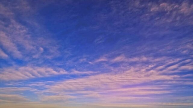 sky timelapse - golden sundown scene with small clouds - loop video
