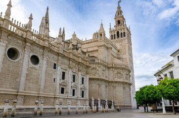 Seville cathedral showing majestic architecture and giralda tower under blue sky