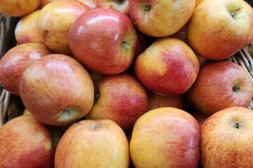 Large group of fresh red fuji apple in basket on display in the supermarket or grocerie store, close up photo