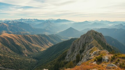 Naklejka premium A breathtaking panoramic view of majestic mountain ranges stretching to the horizon under a partly cloudy sky showcasing autumnal hues.