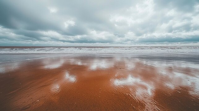 A beach scene with a cloudy sky as an approaching storm creates an atmospheric and dramatic background over the ocean - Powered by Adobe