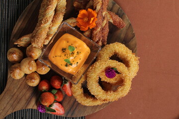cheese platter assorted savory snack with cheese sauce in the center