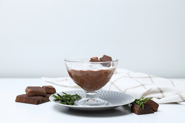 Chocolate mousse and ingredients on a light background.