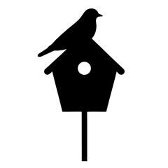 Silhouette of a bird perched atop a classic birdhouse design