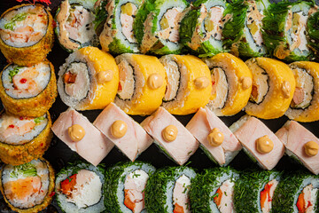 A vibrant array of sushi rolls features creative ingredients and flavors, inviting indulgence