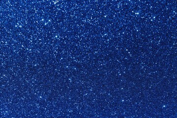 A shiny and sparkling dark blue glitter texture background with bright spots