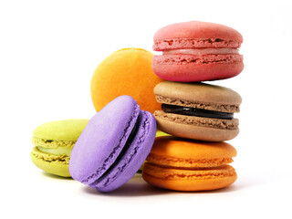 Pile of macaron cookies in various flavours and colours isolated on white background.