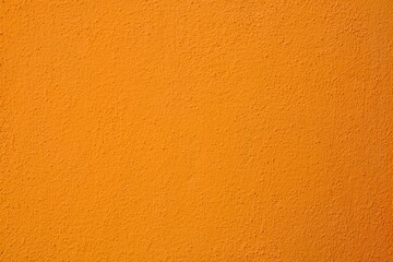 An orange textured wall with a slightly rough and uneven surface texture