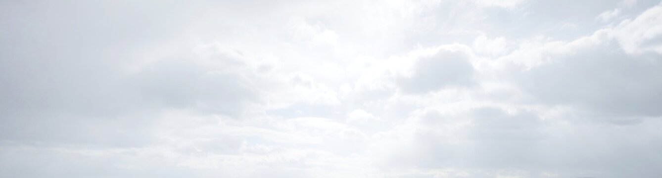 white sky cumulus clouds shiny sunlight background banner