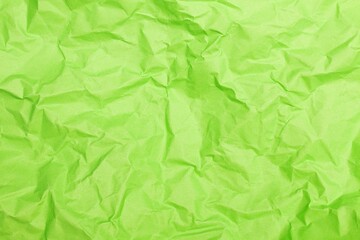 Close up shot of light green wrinkled paper creating an abstract background