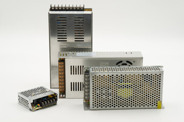 Multiple size of switching power supplies isolated on white background for electronics tasks