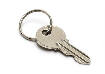 A close up of a silver metal key with a ring attached on a white background in a studio shot