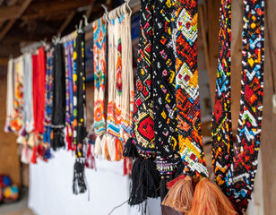 Intricate beadwork of traditional Chilean indigenous crafts, such as necklaces or headbands, showcasing detailed handcrafting skills.