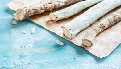 Raw Ashwagandha Root Sticks on Blue Textured Background for Herbal Remedy